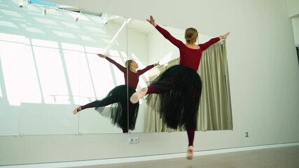 Graceful ballerina performing pirouettes in a bright dance studio - Powered by Adobe