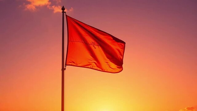Urgent red flag waving in the wind against a vivid sunset sky, hinting at danger and caution with fiery sunset colors