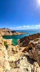 High-angle view of a turquoise lake nestled in a desert landscape