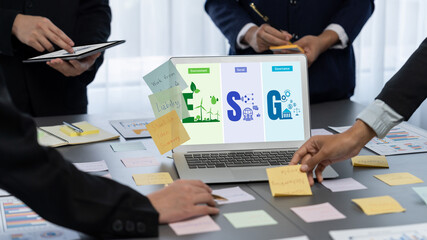 Analyst team use sticky note for creative and analytic brainstorm for business idea with BI data dashboard on laptop screen. Analysis financial data visualization tech for marketing strategy. Prodigy