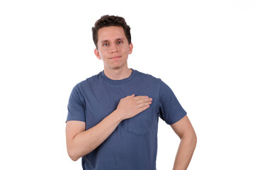 Fototapeta premium Proud man wearing a blue shirt on a white background, pointing at himself