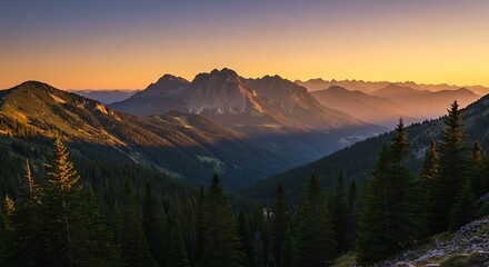 Obraz premium Scenic mountain landscape at sunset with warm colors and layered silhouettes