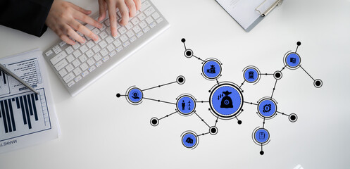 A creative office workspace featuring a keyboard, notepad, and digital finance concepts. Explore...