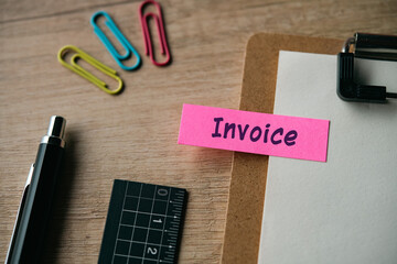 There is sticky note with the word INVOICE. It is as an eye-catching image.