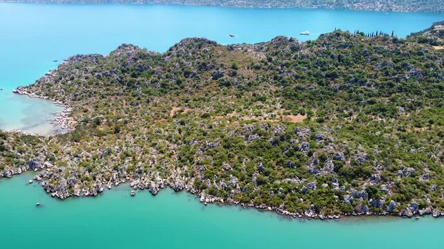aerial perspective showcasing the historic Simena Castle Kalek&ouml;y and the stunning turquoise waters and lush coastline of Kekova Island in Antalya, Turkey.