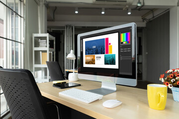Graphic designer software for modern design of web page and commercial ads showing on the computer screen