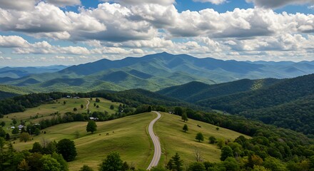 Scenic mountain landscape with winding road under a cloudy blue sky