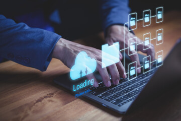 Businessman typing on laptop computer with holographic cloud storage and digital folders,...