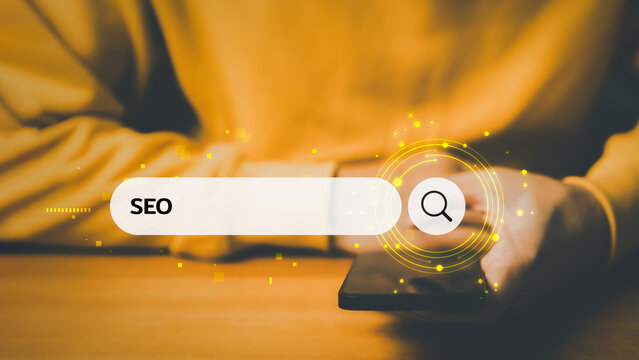 Person using smartphone with glowing SEO search bar interface, symbolizing search engine optimization, digital marketing strategy, website ranking, and online business growth.