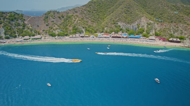 Clear Day Drone Footage of Active Beach, Speedboats, and Touristic Towers &ndash; Playa Blanca, Santa Marta