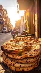 Stacked flatbreads at sunset in a city street