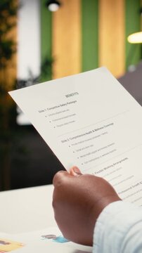 Vertical Video Close up of applicant reviewing monthly perks and medical subscription options, meeting with a recruiter to go over the benefits package for work contract. Reaching an agreement. Camera