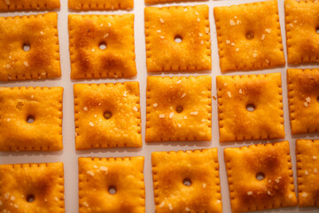 Closeup of Square Salted Cheez it Crackers on white background lined up