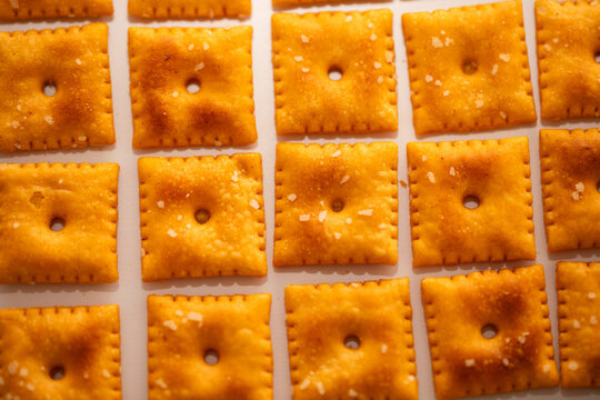 Closeup of Square Salted Cheez it Crackers on white background lined up