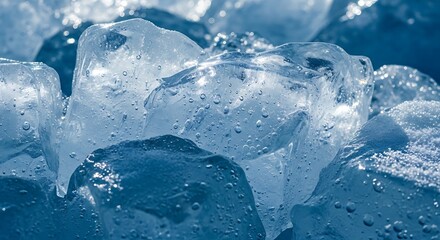 Closeup of sparkling ice cubes with refreshing and cold, and against a blue background.
