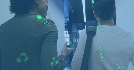 Executives walking hallway discussing sustainability data as green icons materializing around them - Powered by Adobe