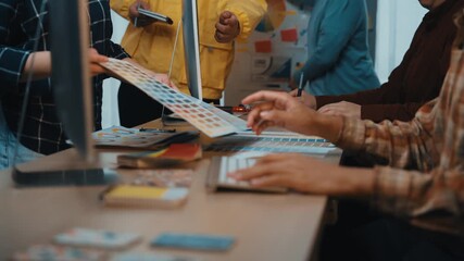 A diverse team of professionals engages in collaborative brainstorming and planning activities at a modern workspace, surrounded by charts, tablets, and creative materials. SACTR