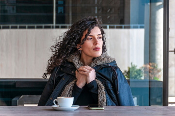 Woman drinking coffee break at outdoor café table