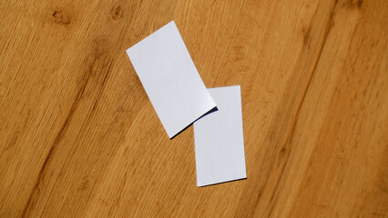 Plain business card paper on the wooden table surface