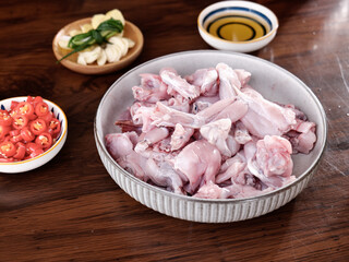 Fresh Raw Chicken Pieces with Spicy Ingredients for Asian Cooking on Wooden Table
