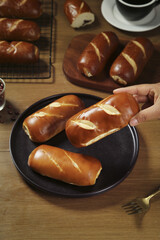 Handmade Lye Bread Rolls on Plate with Coffee - Traditional Savory Baked Goods