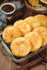 Traditional Chinese Flaky Pastry Buns from Shaanxi Bakery with Sauce on Wooden Table