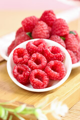 Fresh Red Raspberries in White Bowl on Wooden Table - Healthy Organic Fruit