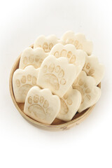 Cute Bear Paw Shaped White Sandwich Cookies in Wooden Bowl on White Background