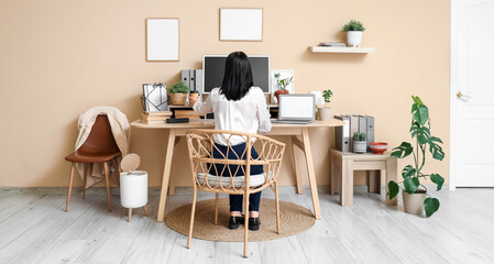 Young woman having cup of coffee at workplace in office