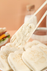 Bear-shaped sandwich bread with chopsticks and hamburger in kitchen