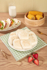 Adorable Bear Paw Steamed Buns with Asian Food Spread on Wooden Table