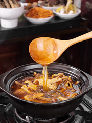 Golden Mushroom Soup with Premium Ingredients - Traditional Chinese Cooking with Wooden Ladle and Spices