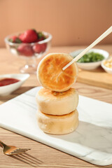 Roasted Golden Pancakes Stack with Fresh Strawberries and Colorful Sauces on Wooden Table