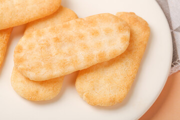 Crispy Rice Crackers on White Plate - Light Golden Snack Food