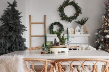 Dining table with candles and Christmas decor in light room