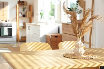 Vase on dining table in light modern kitchen