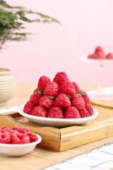 Fresh Red Raspberries on White Plate with Wooden Board - Healthy Organic Fruit Food Photography