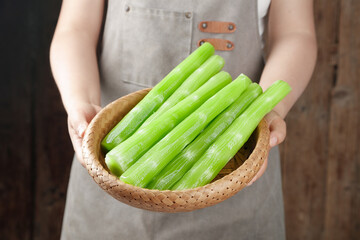 Fresh Green Celery Stalks in Wicker Basket - Healthy Organic Vegetables for Cooking