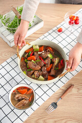 Homemade Duck Stew in Country Kitchen Casserole Pot with Fresh Vegetables and Herbs