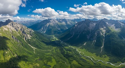 Naklejka premium Aerial view of majestic mountain range with green valleys and blue sky