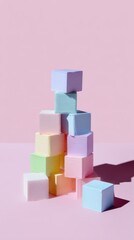 Obraz premium A playful arrangement of pastel-colored cubes stacked against a soft pink background, creating a minimalist and visually appealing display.