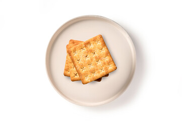 Stack of crackers in ceramic plate isolated on white background. top view
