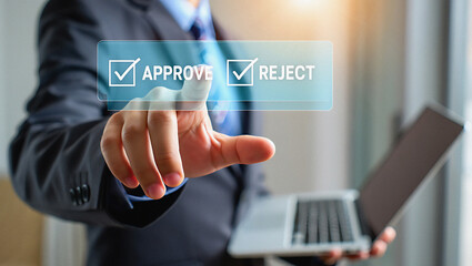 Business professional using touchscreen technology to complete a digital checklist for efficient task management and goal achievement in modern work environments.