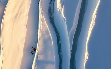 Abstract close-up snow texture illuminated by bright sunlight golden hour warmth
