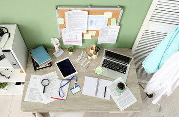 Interior of office with medical student's workplace and pin board, top view