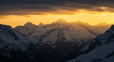 Fototapeta premium Mountain peaks glowing at sunset with snow
