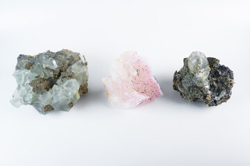 Three mineral stones together, pink manganoan calcite, cubic fluorite with pyrite, and galena lead...