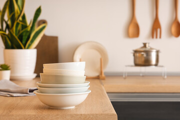 Stack of bowls on table in kitchen, closeup