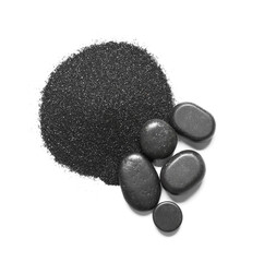 Heap of black beach sand with pebbles on white background