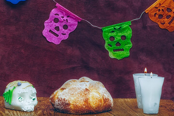 Bread of the dead with a background decorated with candles and sugar skull, tradition of the day of...